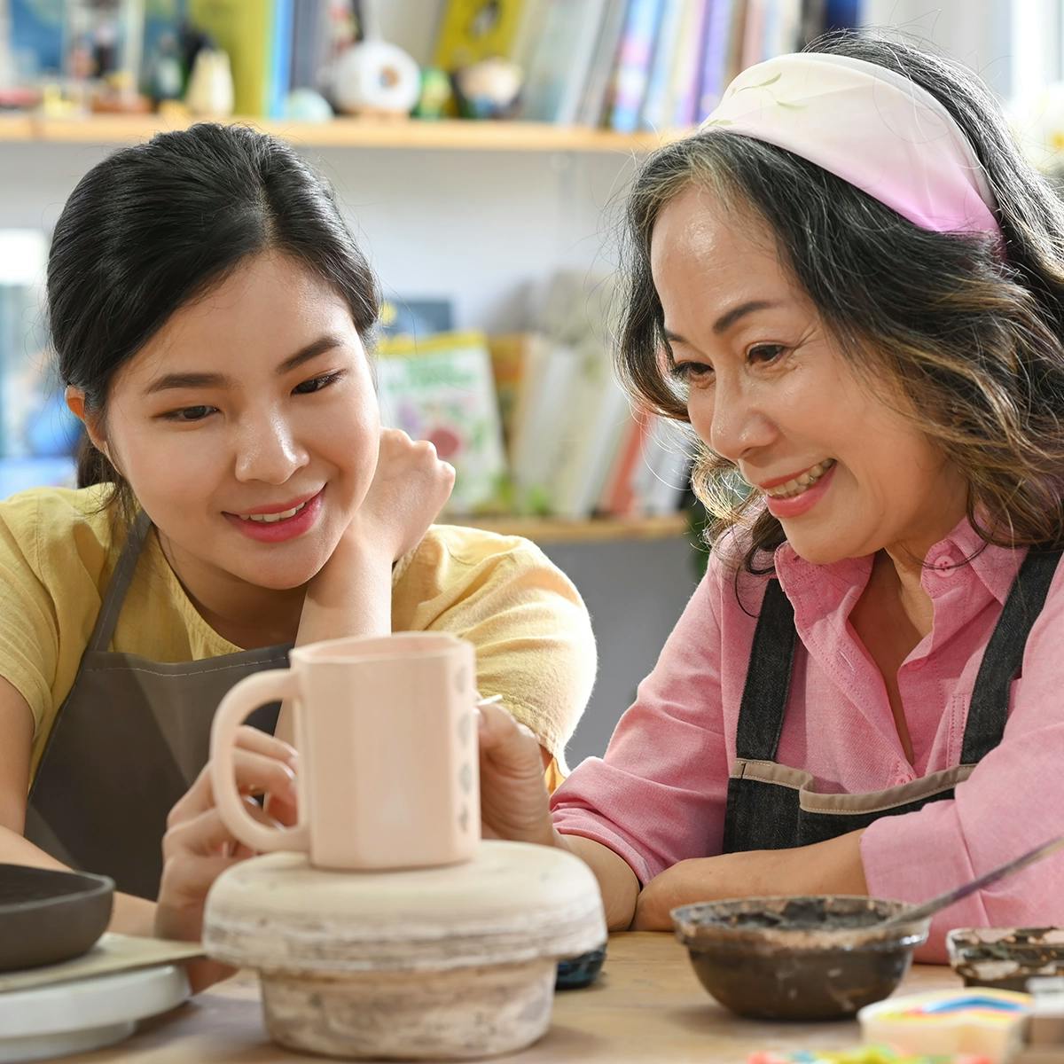 Asian mother and daughter attending a pottery class for Mother’s Day