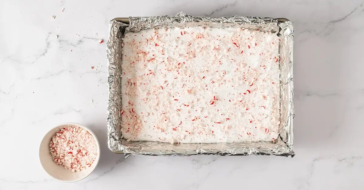 Homemade marshmallows in a pan, sprinkled with crushed candy canes for Christmas.