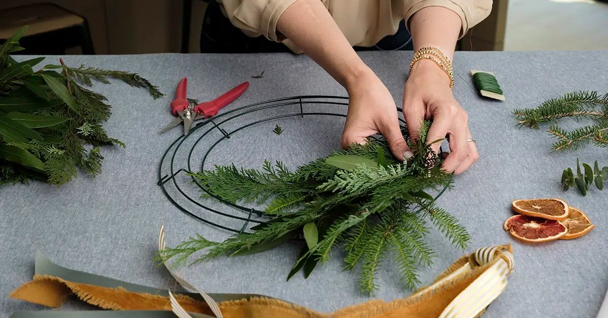 Creating a small bundle of greens for a Christmas wreath.
