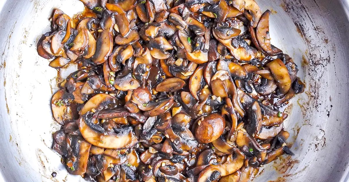 Mushrooms sautéed in butter to make a vegan holiday appetizer.