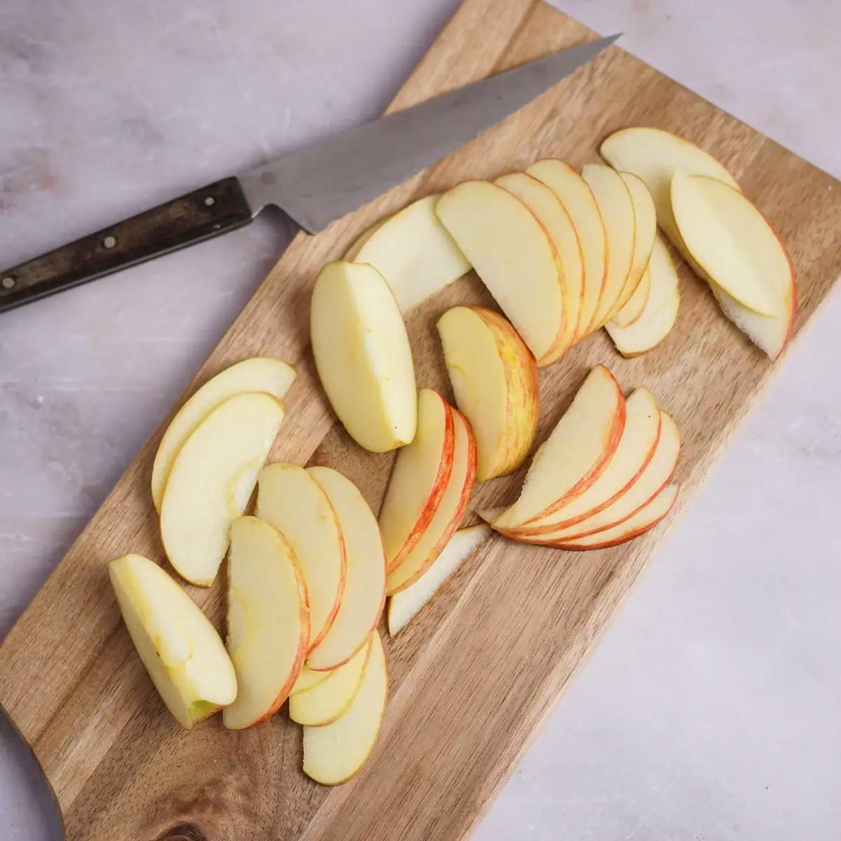 Slicing apples into slices ready to go into a Christmas salad with fruit.