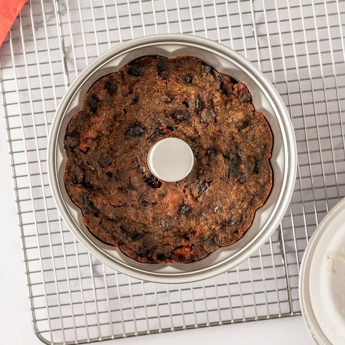 A Christmas Plum Pudding cooling on a rack.