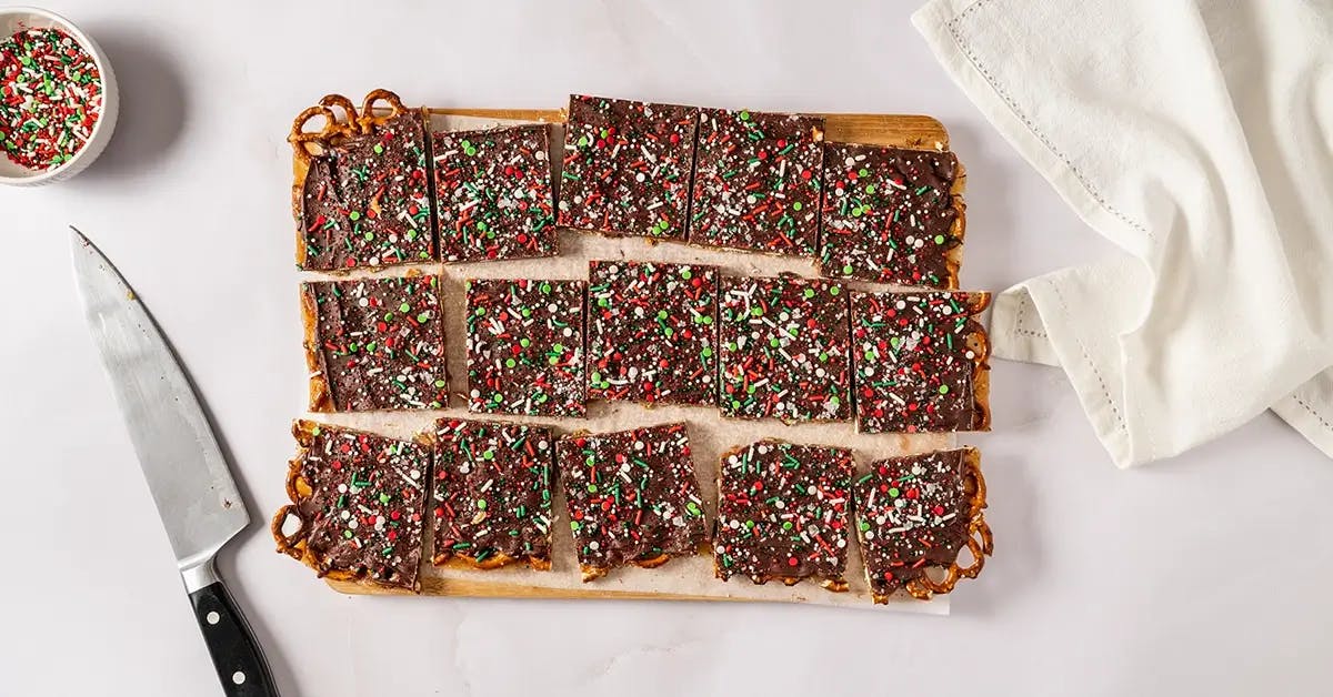A tray of Christmas Crack with Pretzels, cut into individual pieces