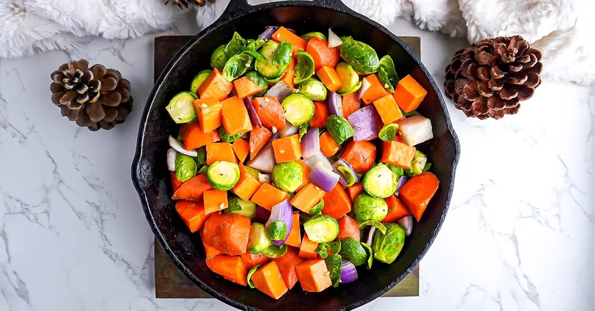 Seasoned mixed vegetables in a skillet, ready to go into the oven.