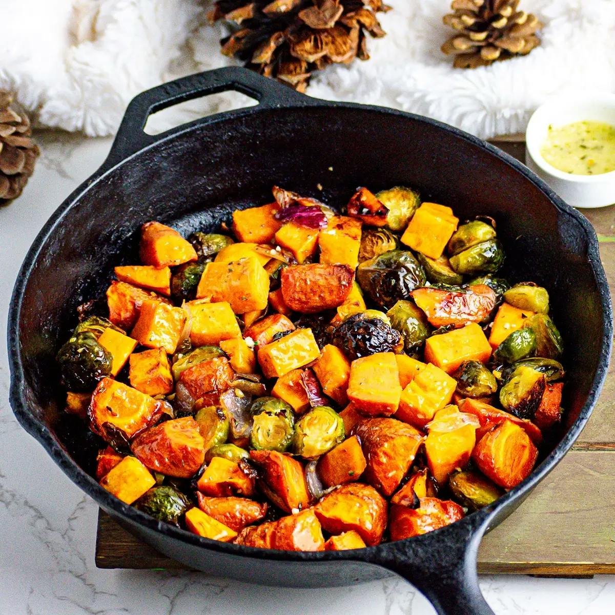 Oven roasted vegetables in a skillet, a Thanksgiving or Christmas side dish.