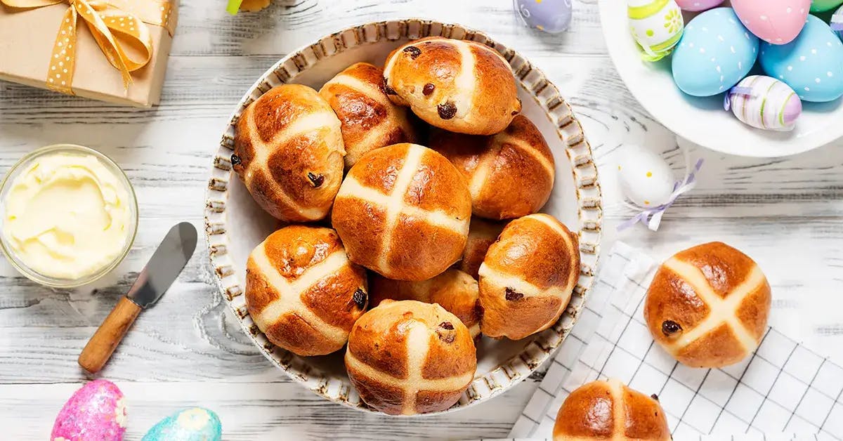 A plate of hot cross buns on the table for Easter brunch.