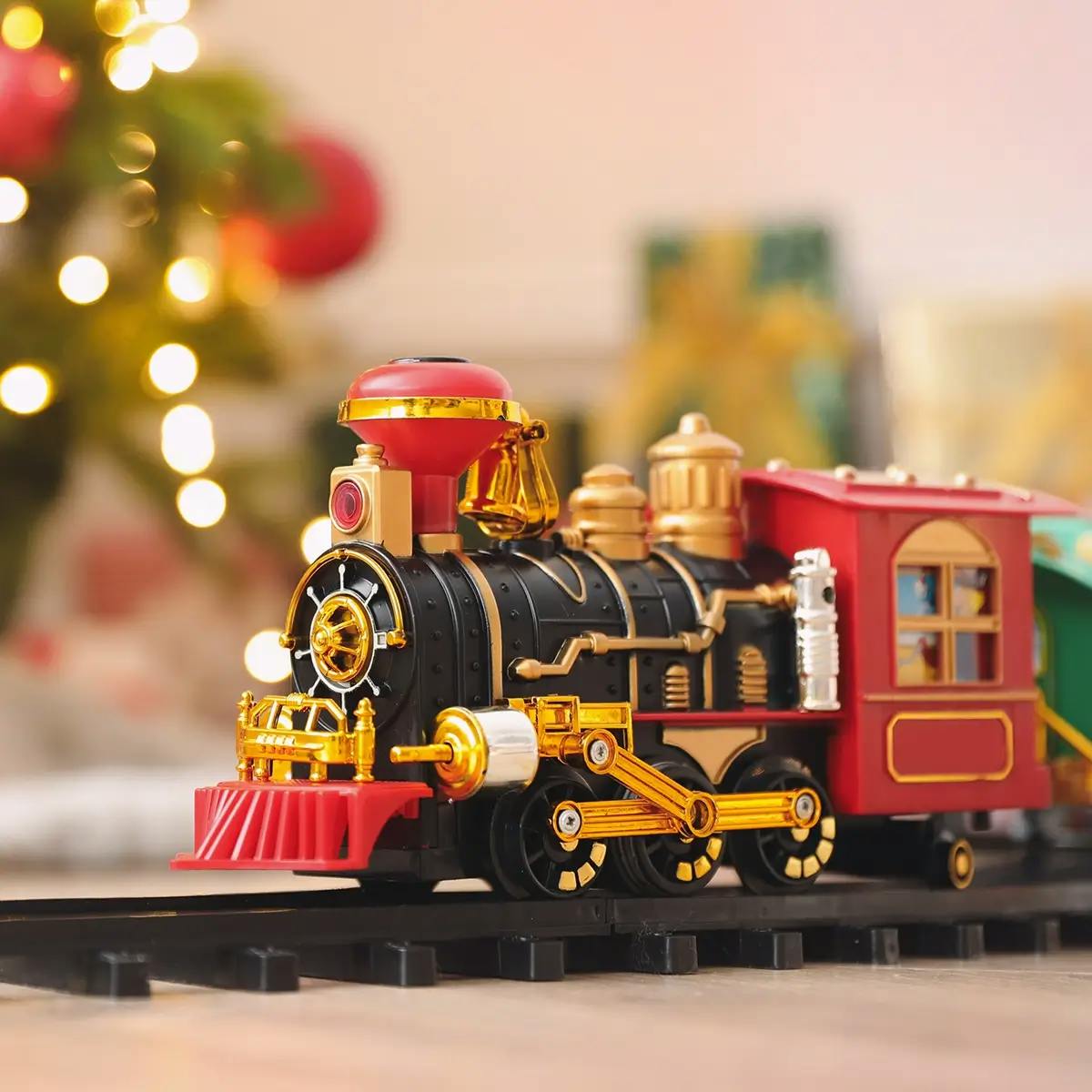 Closeup of a model train under a Christmas tree.