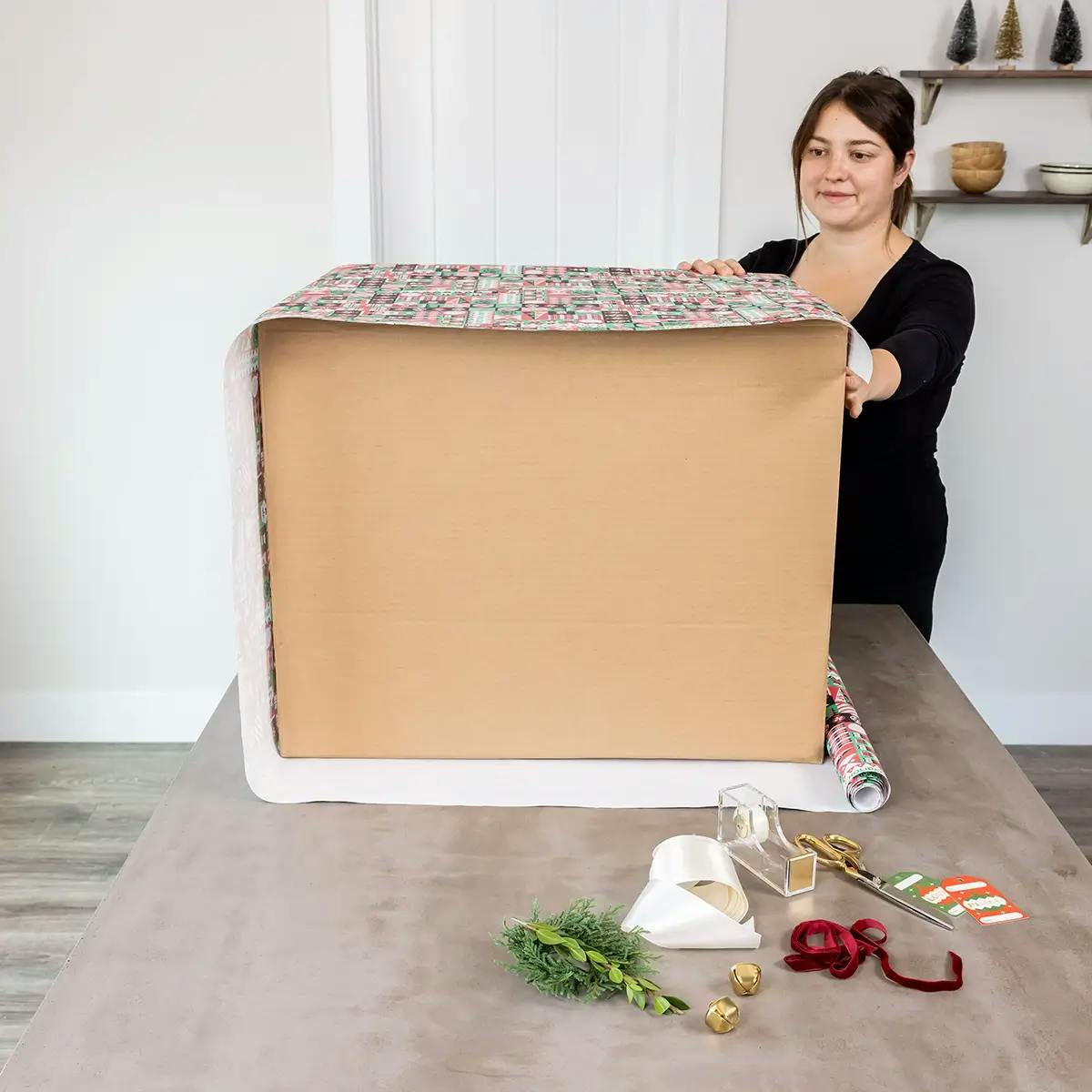 Securing wrapping paper to a large box.