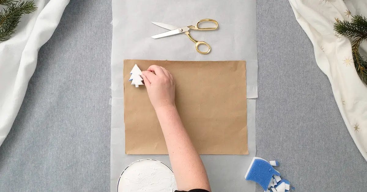 Making custom wrapping paper with a DIY stamp in the shape of a tree.
