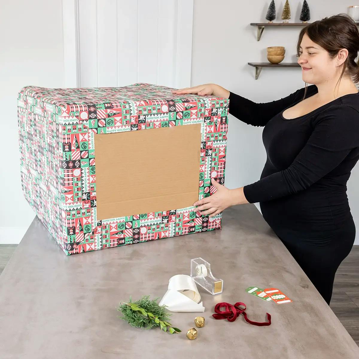 Folding wrapping paper over the ends of a large box.