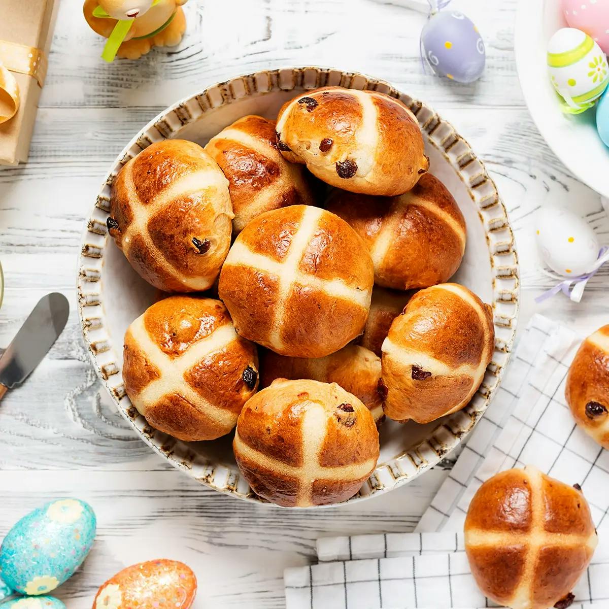 A plate of hot cross buns on the table for Easter brunch.