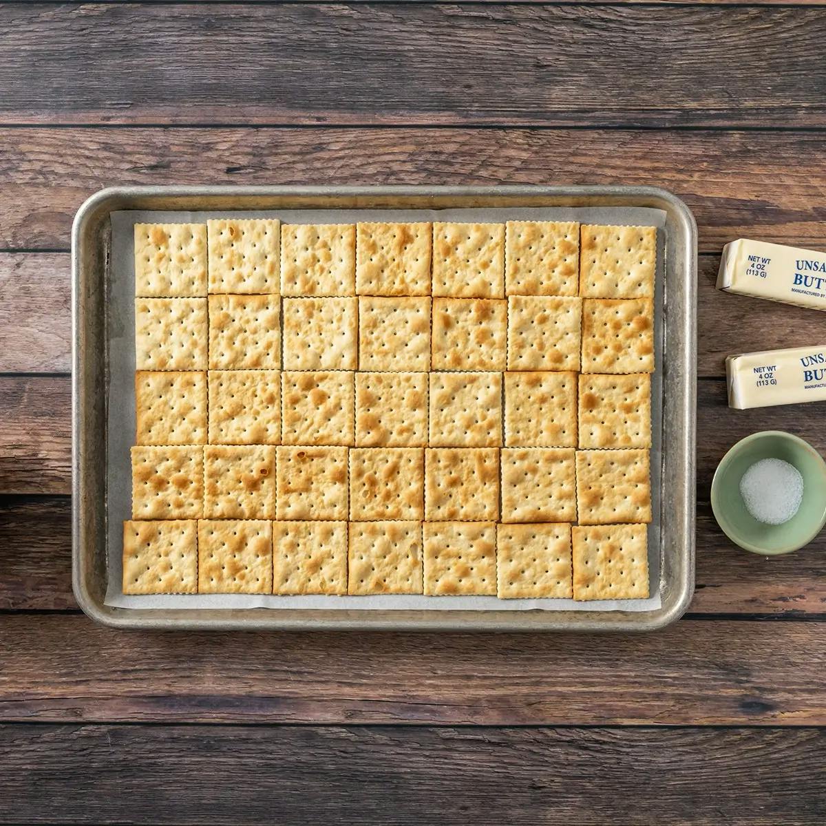 A layer of Saltines on a baking tray at the bottom of Christmas Crack.