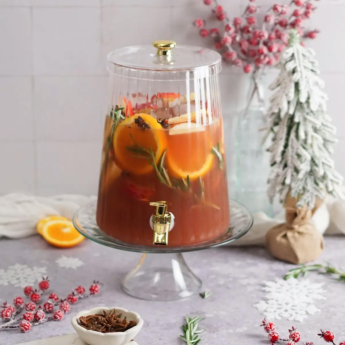 Cranberry juice and fruit in a large pitcher, ready to be made into a non-alcoholic holiday punch.