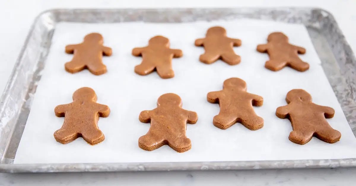 Gingerbread Men cookies on a baking sheet ready to go into the oven.