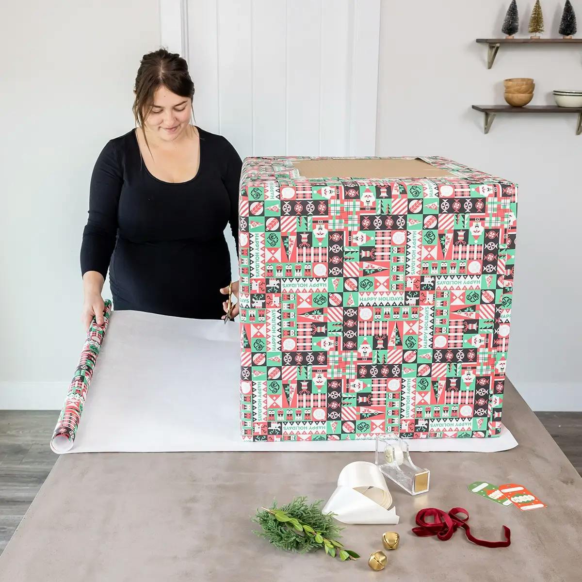 Adding wrapping paper to cover the gaps when wrapping a large box.