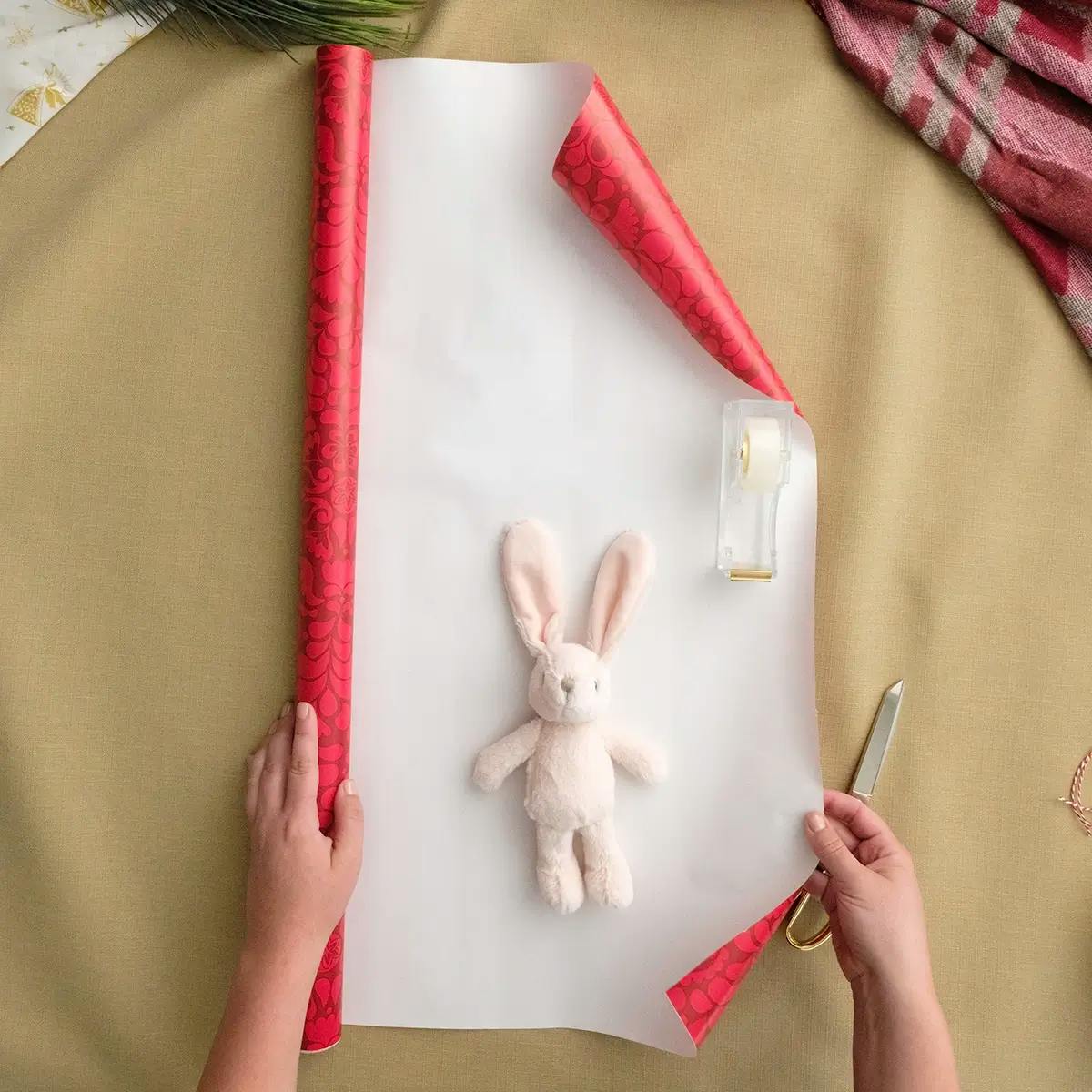 Measuring wrapping paper to make a pouch for odd-sized items.