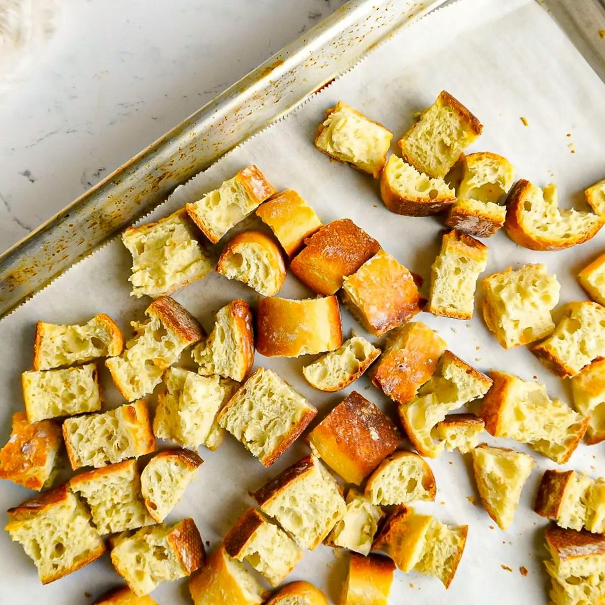 Toasting bread cubes in the oven ready for a vegan stuffing recipe.