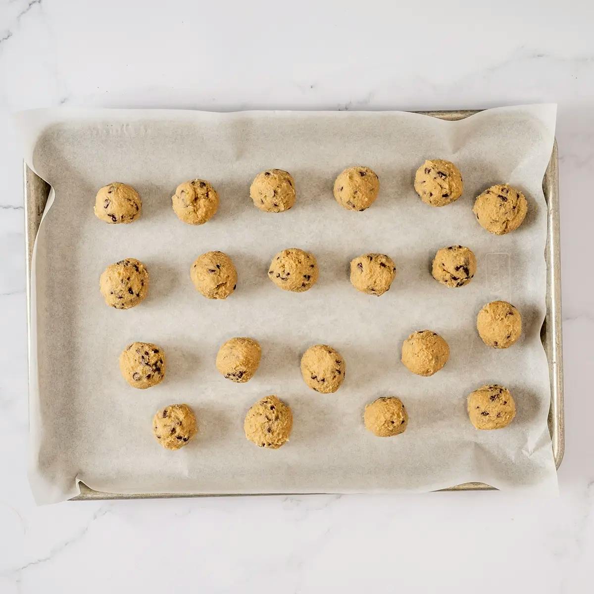 Cookie dough bites on a baking sheet ready to chill in the fridge.
