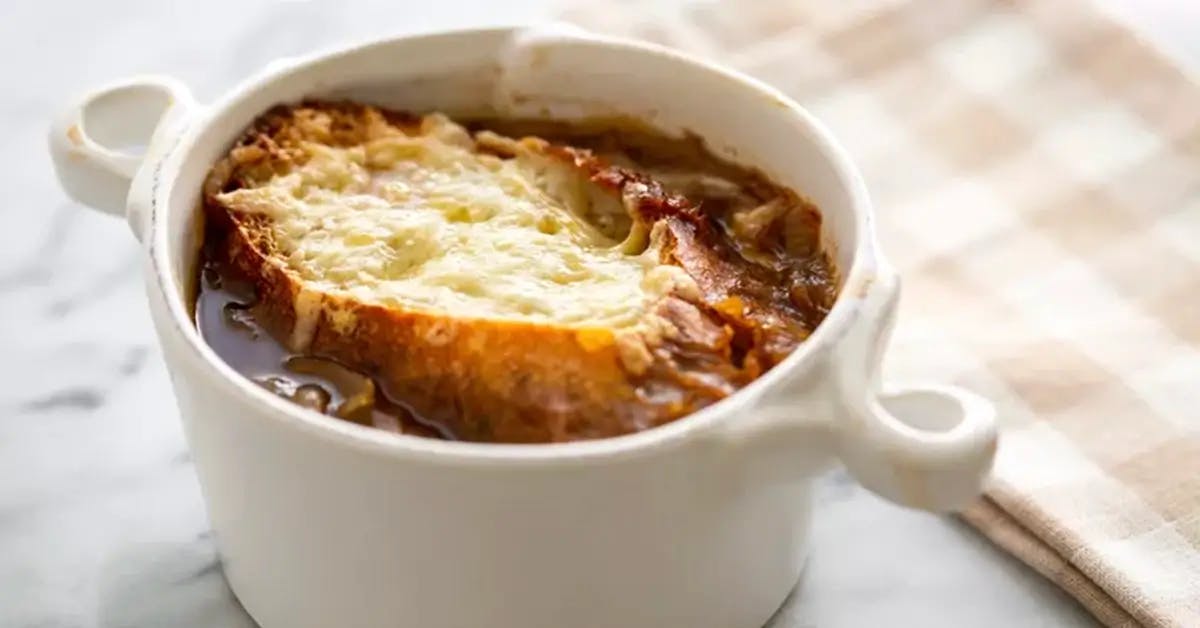 French Onion Soup in a white double-handled soup bowl.
