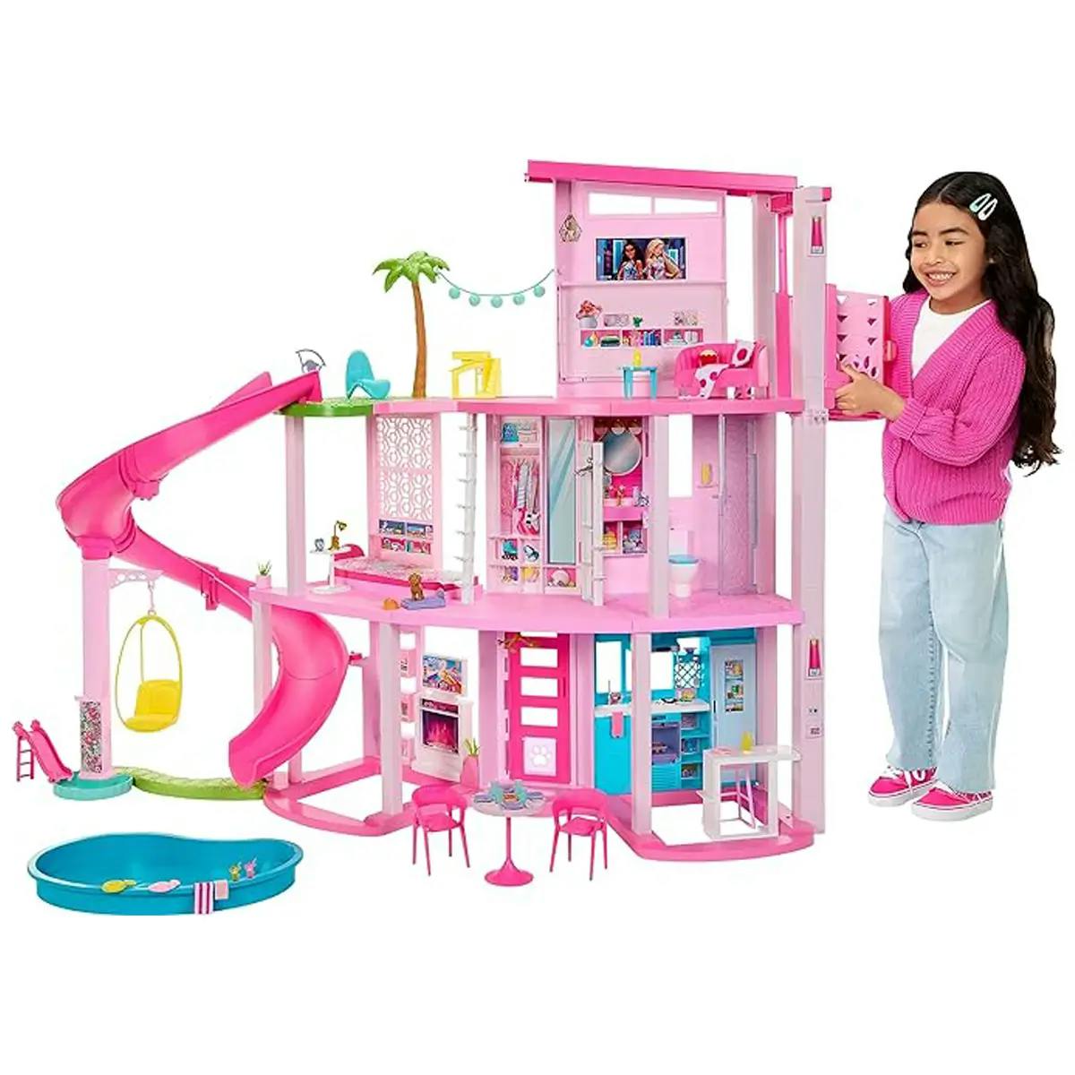 Young girl playing with Barbie Dreamhouse 2023, as shown in Barbie the Movie.