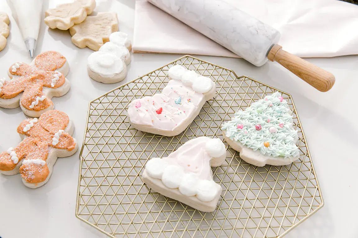 Sugar cookies shaped like gingerbread men, stockings, snowmen, Santa hats, and Christmas trees.