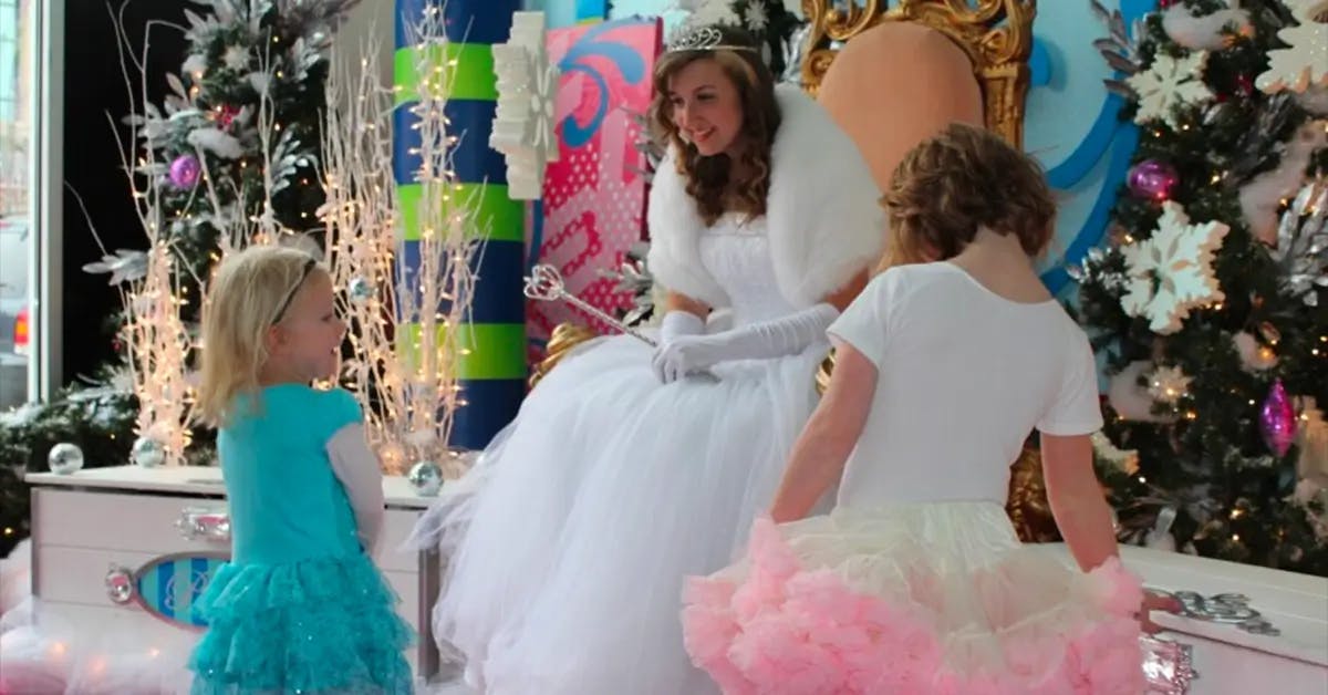 Kansas City Fairy Princess dressed in white, with two young girls dressed in teal and pink princess dresses.