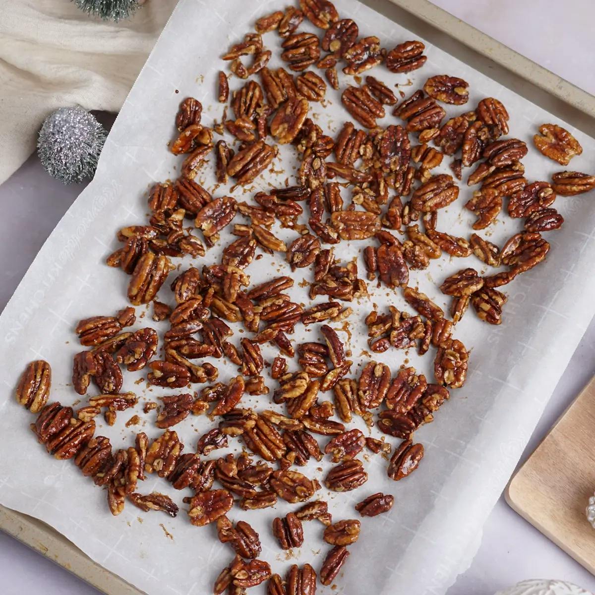 Pecans spread on a baking sheet to cool before being added to a holiday salad recipe.