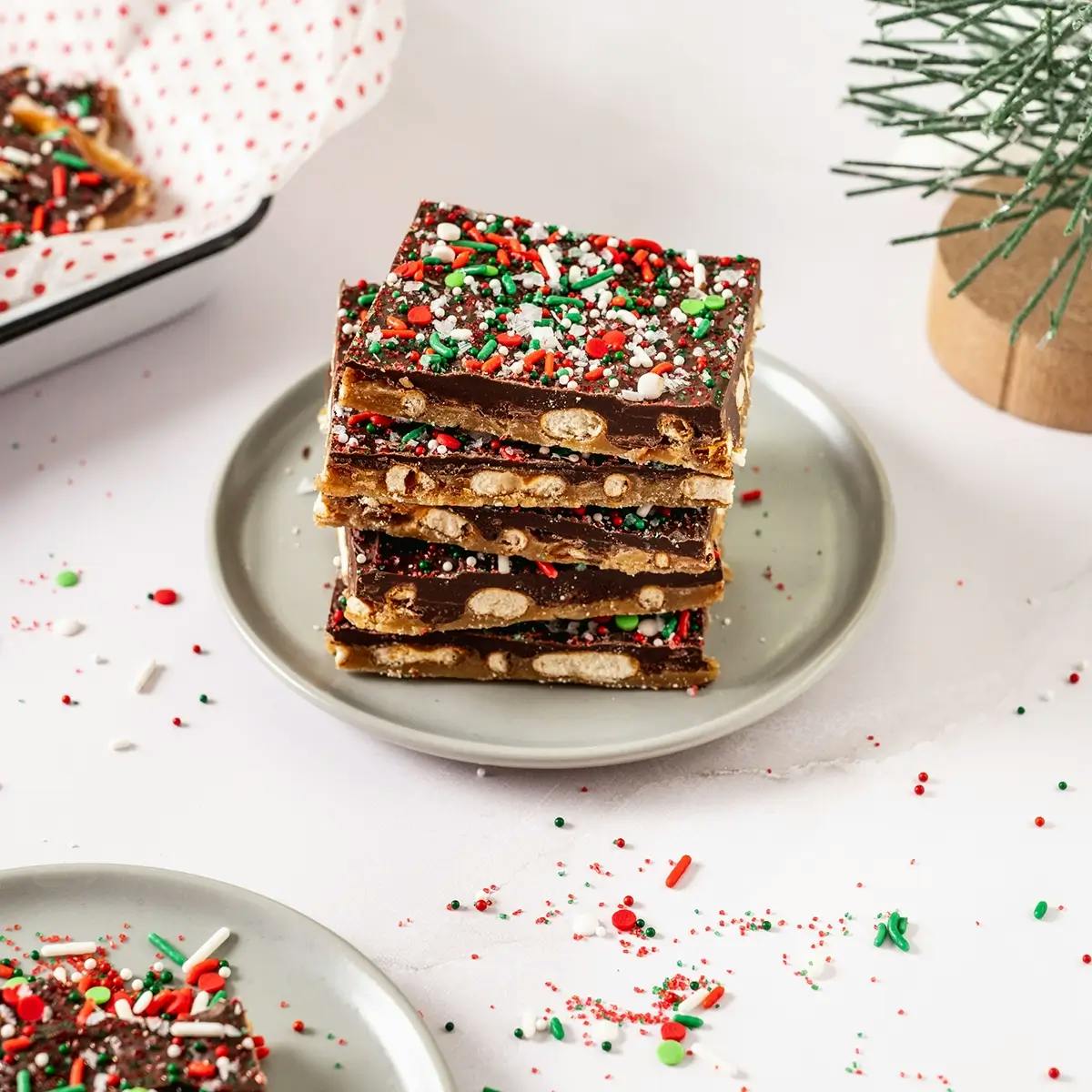 Plate stacked with Christmas Crack made with pretzels and chocolate.