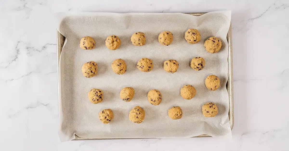 Cookie dough bites on a baking sheet ready to chill in the fridge.