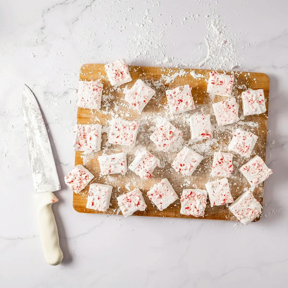 Cutting homemade marshmallows into pieces, ready to gift as Christmas marshmallows.