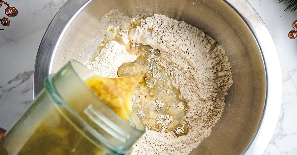 Mixing wheat gluten and seasoned liquid in a recipe showing how to make seitan.