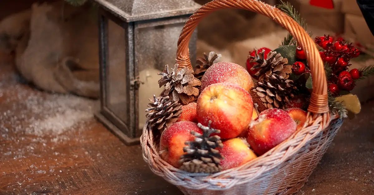 Holiday basket containing apples.