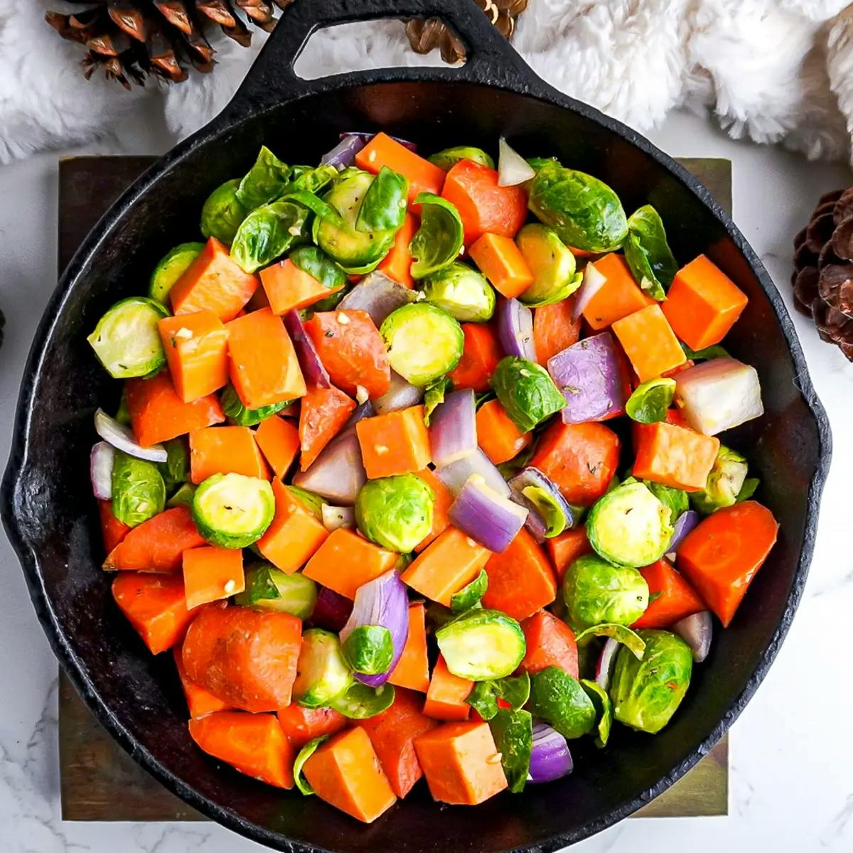 Seasoned mixed vegetables in a skillet, ready to go into the oven.